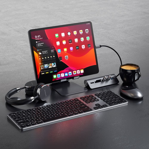 iPad on a stand with periferals such as keyboard and mouse aroung
