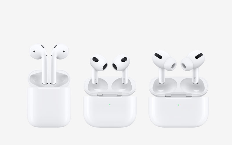 Threee white headphone plugs popping up from their charging case