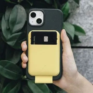 hand holding iPhone with green and yellow cover on