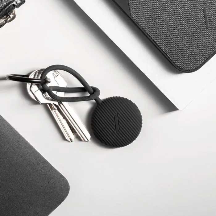 Two keys on a keychain with black AirTag case