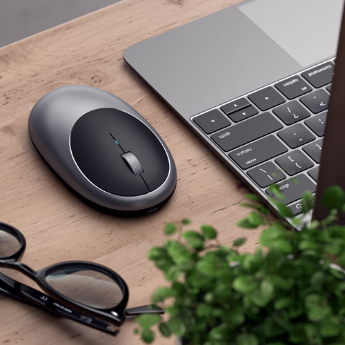 Grey mouse next to a mac