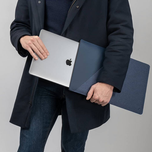 Man holding a blue laptop sleeve